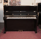 A 2001, Bechstein Elegance 124 upright piano for sale with a black case and brass fittings. Condition as new. Piano has an eighty-eight note keyboard and three pedals