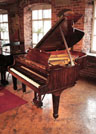 Reconditioned, 1975, Steinway Model A grand piano for sale with a tiger mahogany case spade legs. Piano has an eighty-eight note keyboard and a three-pedal lyre
