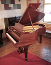 Rebuilt, 1929, Steinway Model M grand piano for sale with a satin, mahogany case and matching stool. Piano has an eighty-eight note keyboard and a two-pedal lyre.