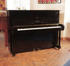 Reconditioned, 1960, Steinway Model Z upright piano for sale with a black case and brass fittings. Piano has an eighty-eight note keyboard and two pedals. 