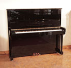 Reconditioned, 1990, Steinway Model K upright piano for sale with a black case and brass fittings. Piano has an eighty-eight note keyboard and three pedals. 